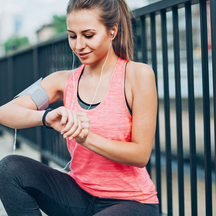 A runner checking her time